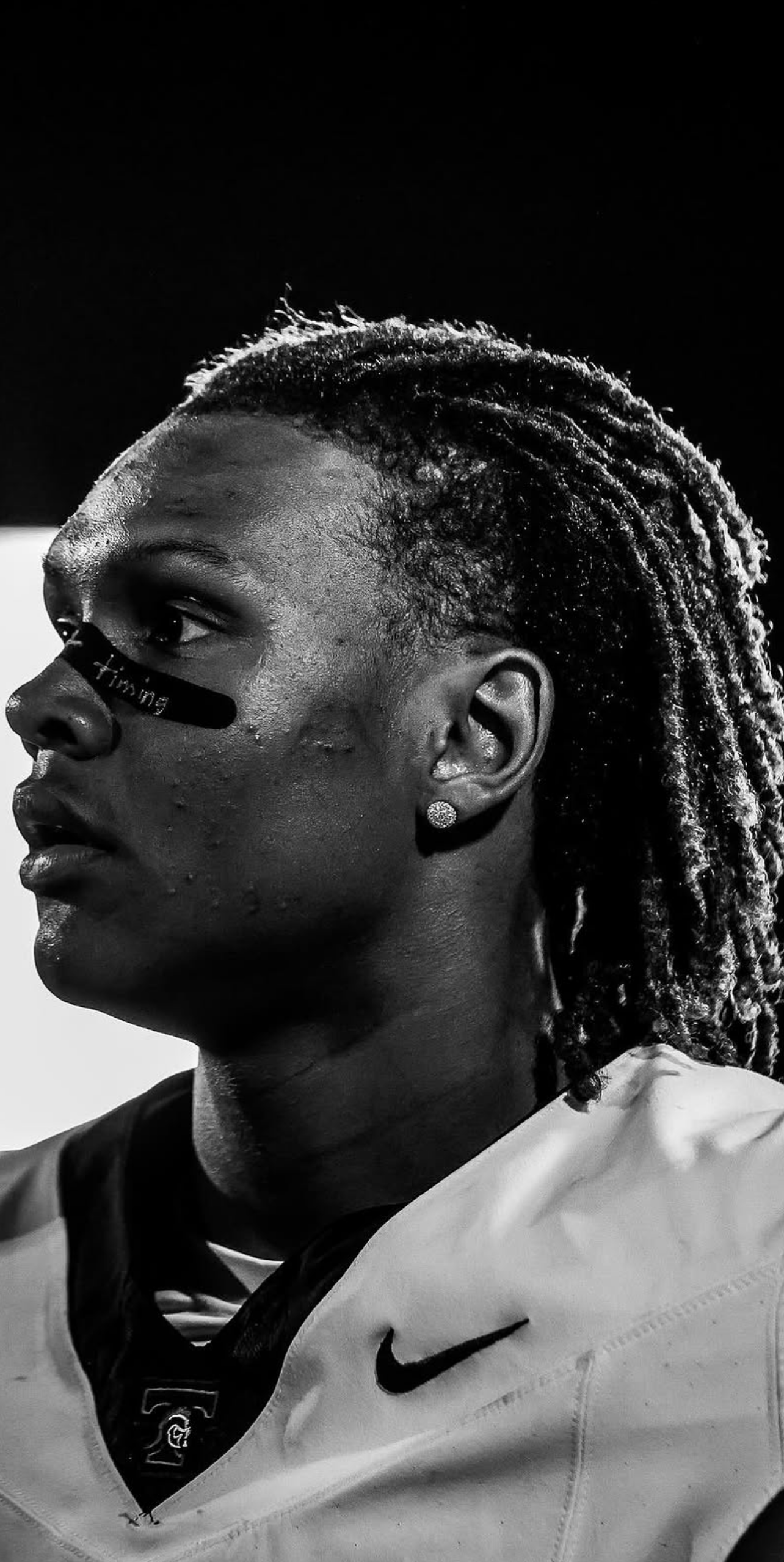 John Meredith III in a black-and-white profile portrait wearing his Nike uniform