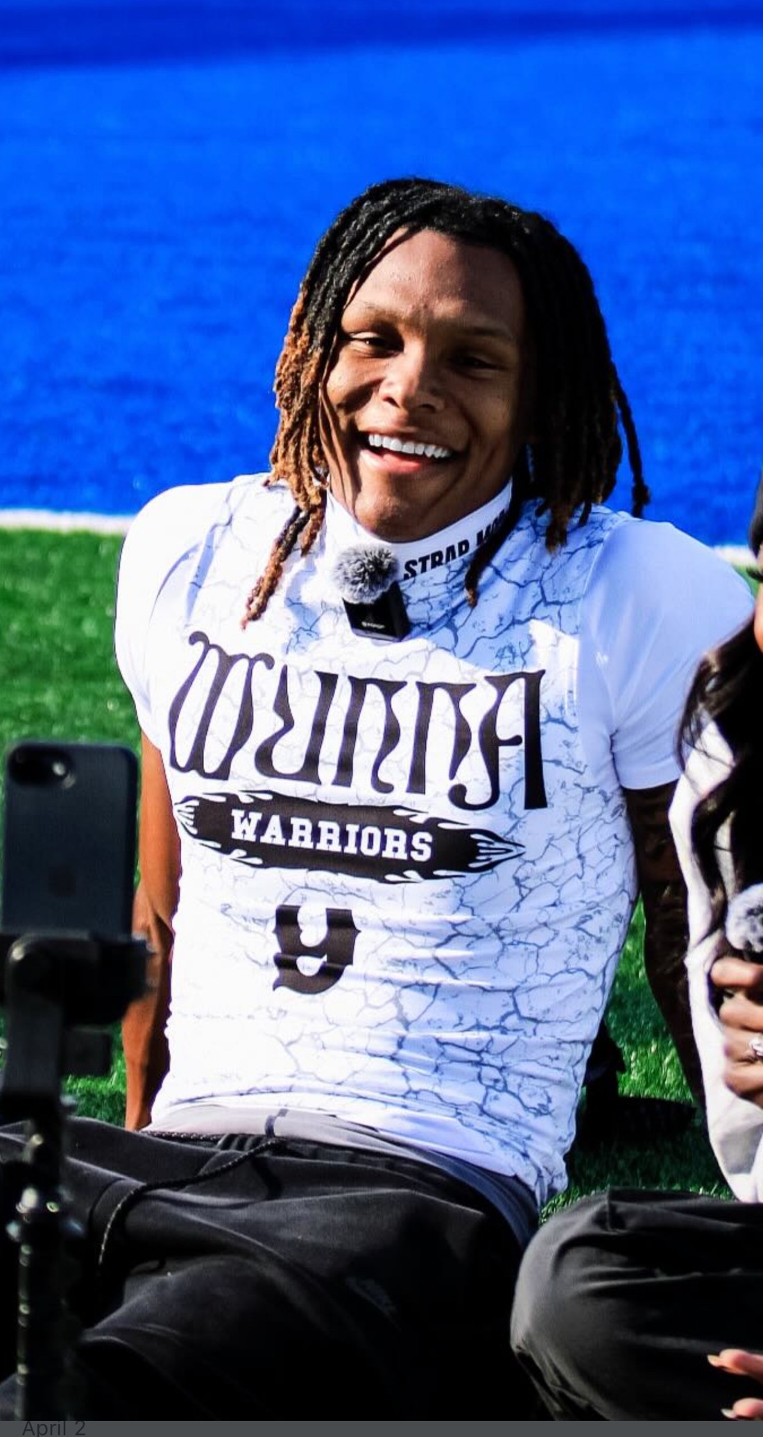 John Meredith III smiling on the sideline